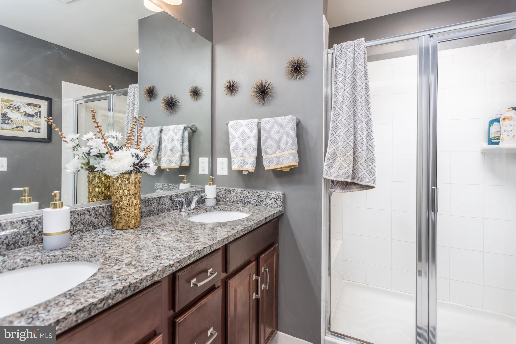 148 Solara Drive Winchester, VA 22602 - Photo 23 of 32 a bathroom with a granite countertop sink and a mirror