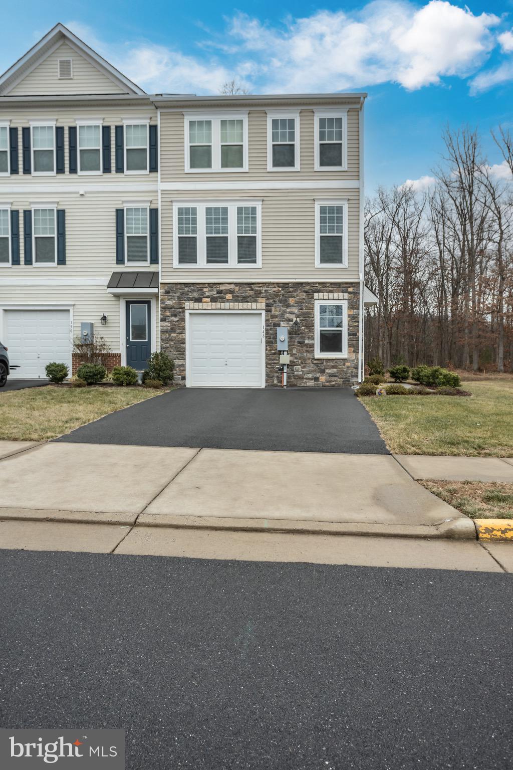 148 Solara Drive Winchester, VA 22602 - Photo 25 of 32 a front view of a house with a yard and trees