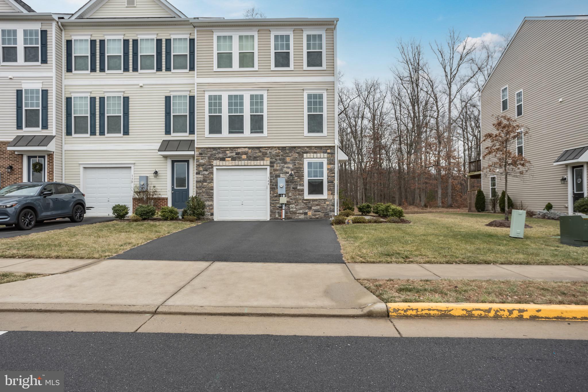 148 Solara Drive Winchester, VA 22602 - Photo 26 of 32 a front view of a house with a yard