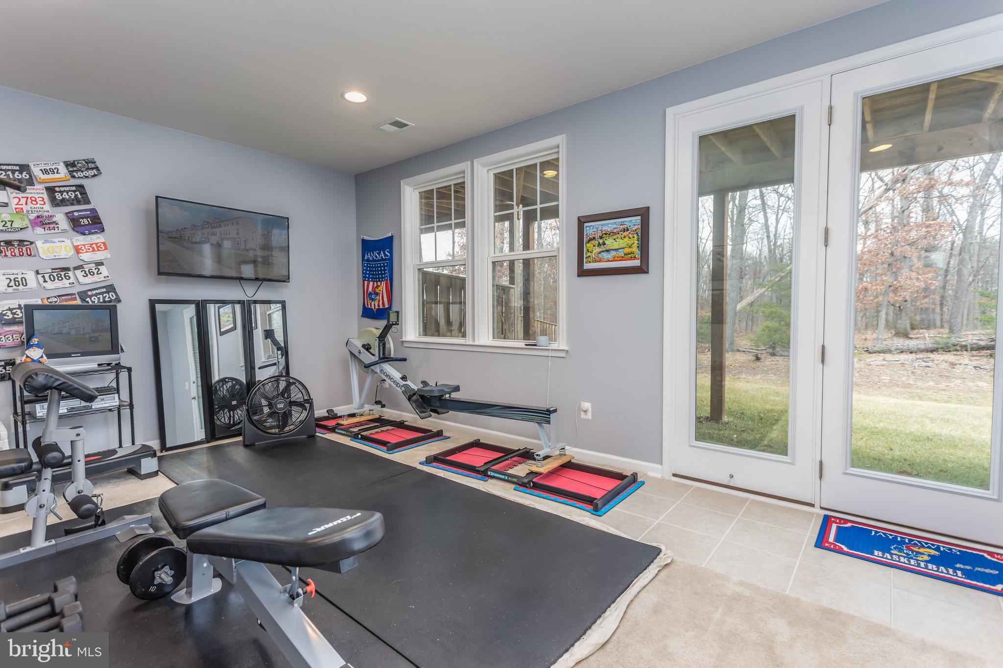 148 Solara Drive Winchester, VA 22602 - Photo 5 of 32 a room with gym equipment and a large window