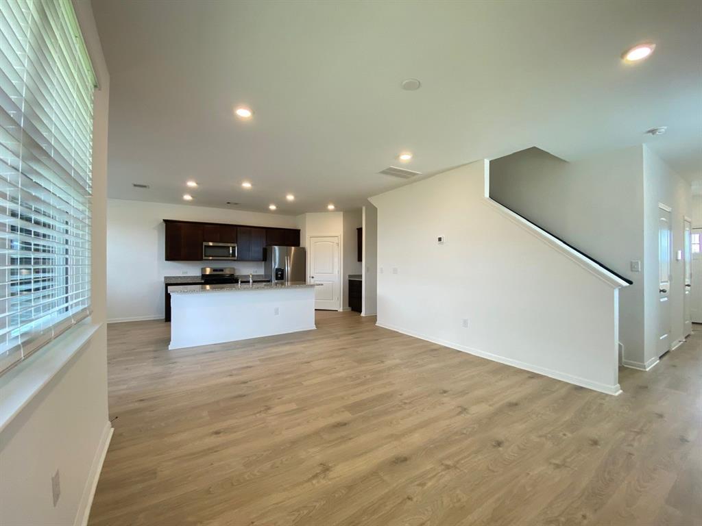 225 Saide Street Georgetown, TX 78626 - Photo 5 of 22 a view of kitchen with kitchen island stainless steel appliances a refrigerator sink and microwave