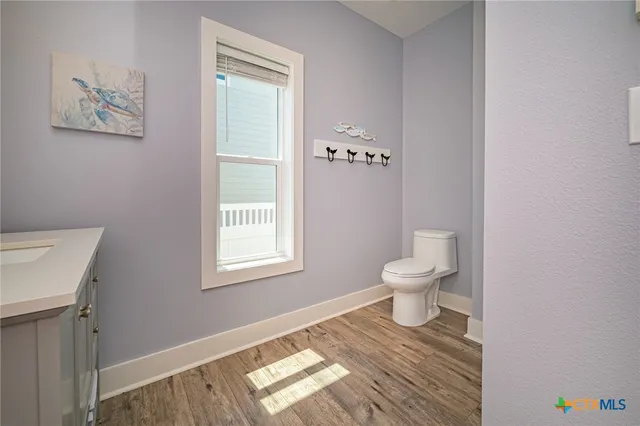 a bathroom with a toilet and a window