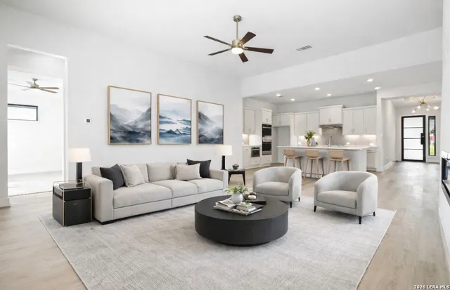 a living room with furniture and kitchen view