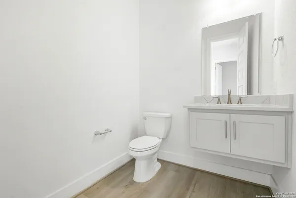 a bathroom with a toilet sink and a mirror