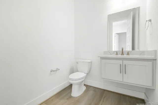 a bathroom with a toilet sink and a mirror