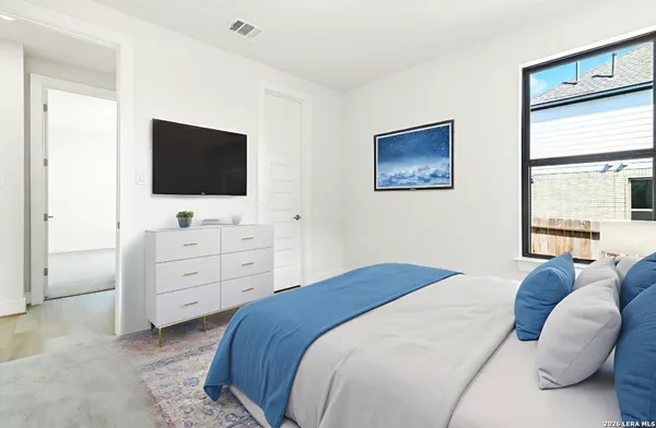 a bedroom with a bed and a flat screen tv
