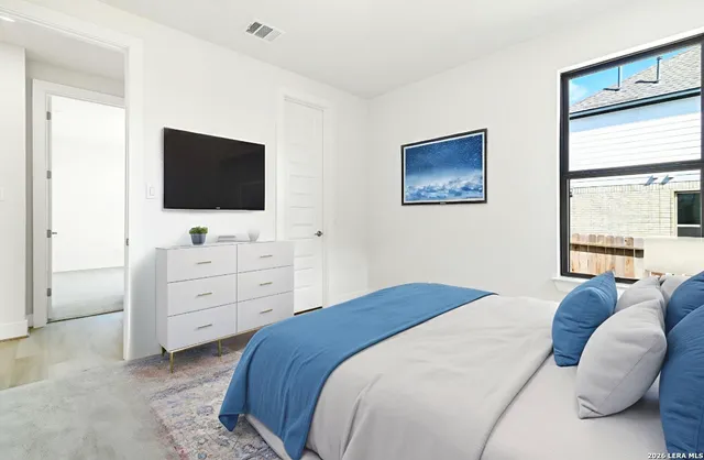 a bedroom with a bed and a flat screen tv