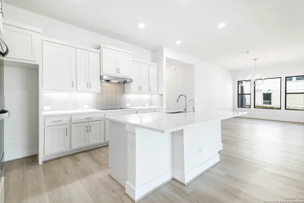 a kitchen with sink and cabinets