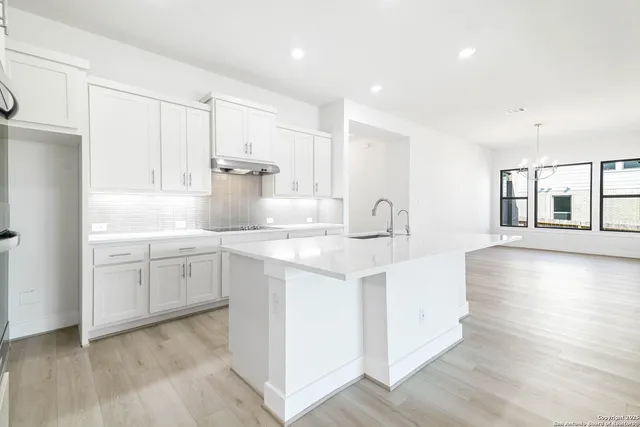 a kitchen with sink and cabinets
