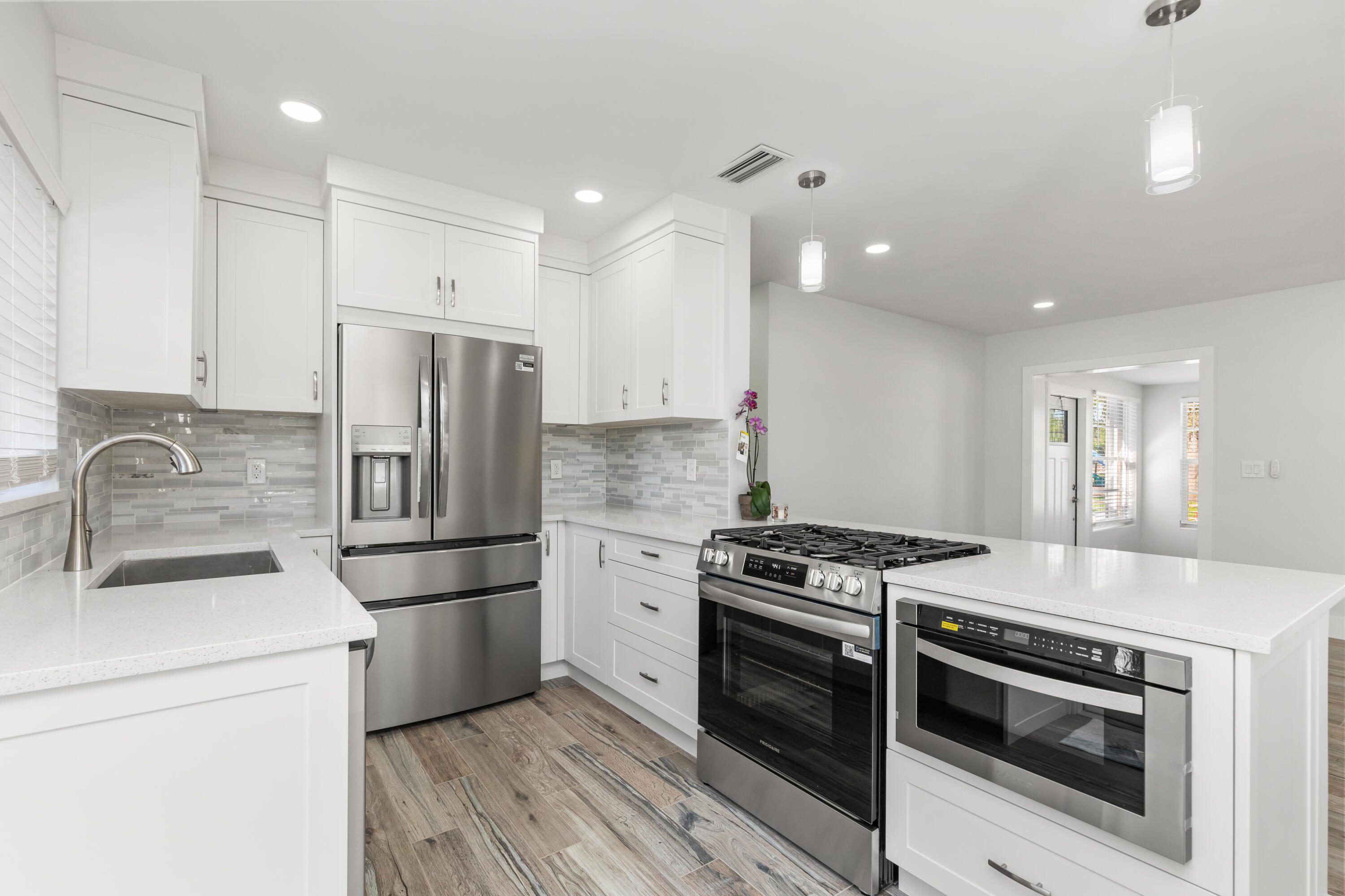 a kitchen with a stove a sink and a refrigerator