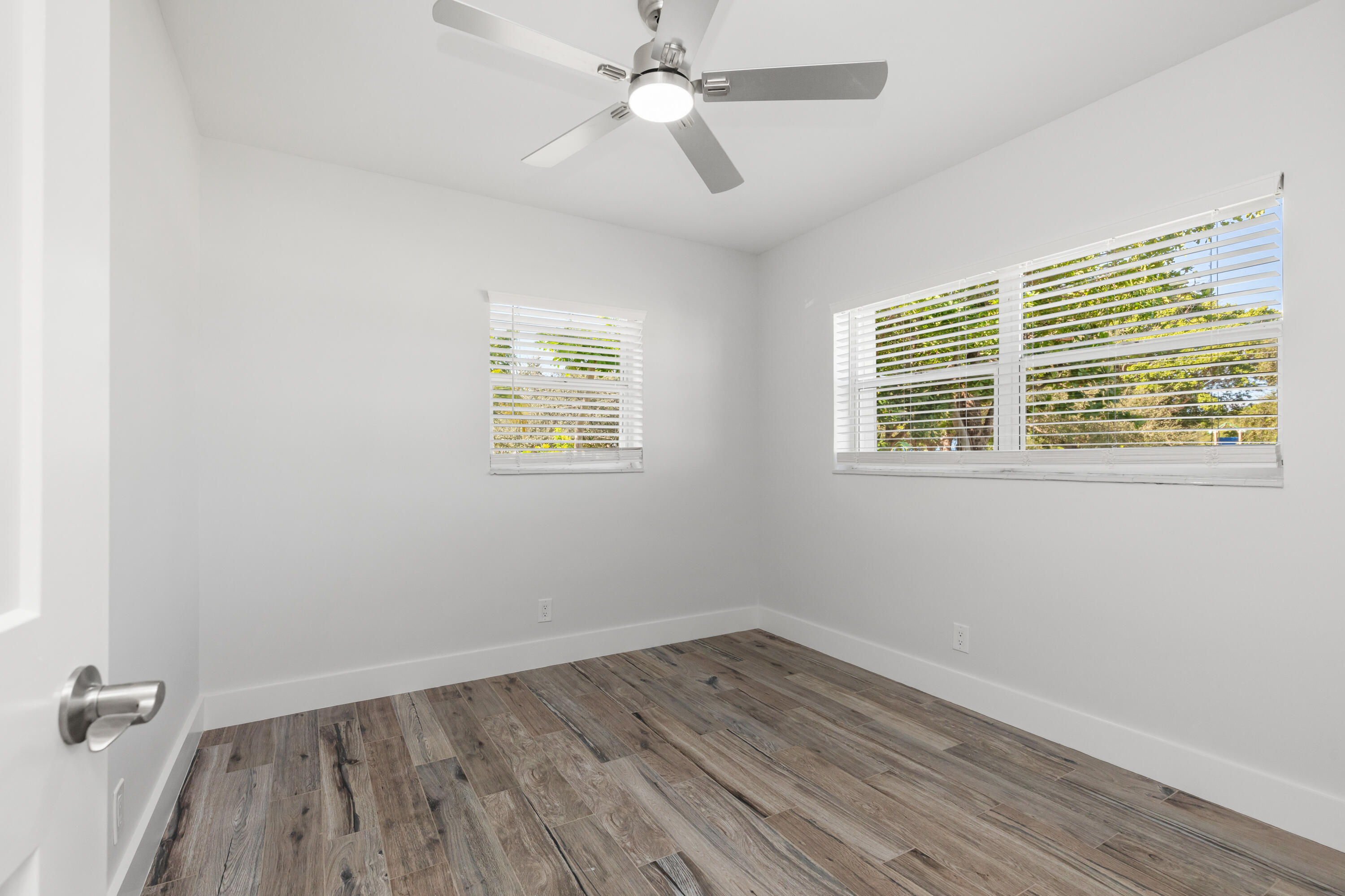 702 South 12th Street Lantana, FL 33462 - Photo 13 of 26 an empty room with a window and wooden floor