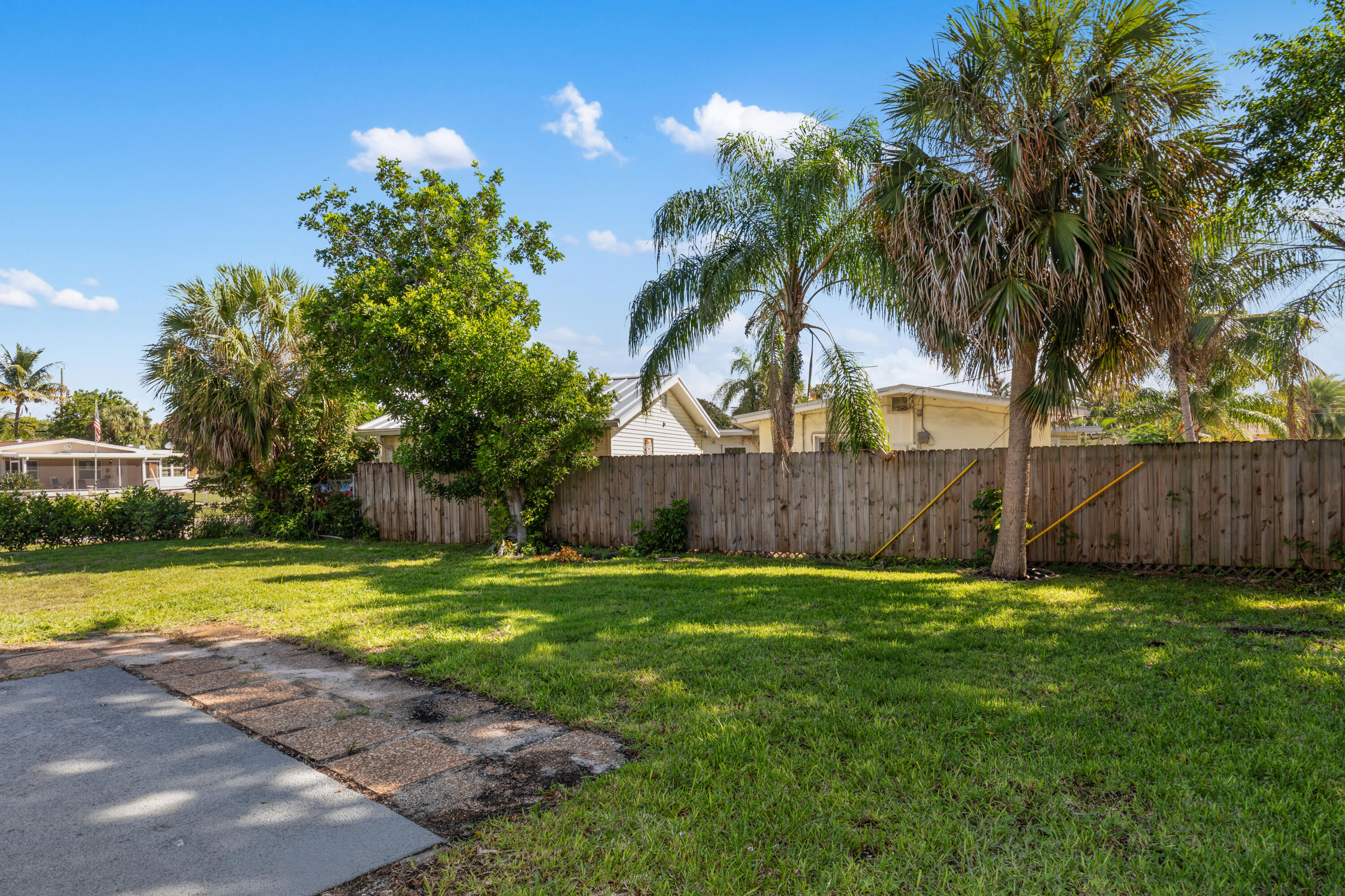 702 South 12th Street Lantana, FL 33462 - Photo 22 of 26 a view of a backyard with a small cabin and a chair