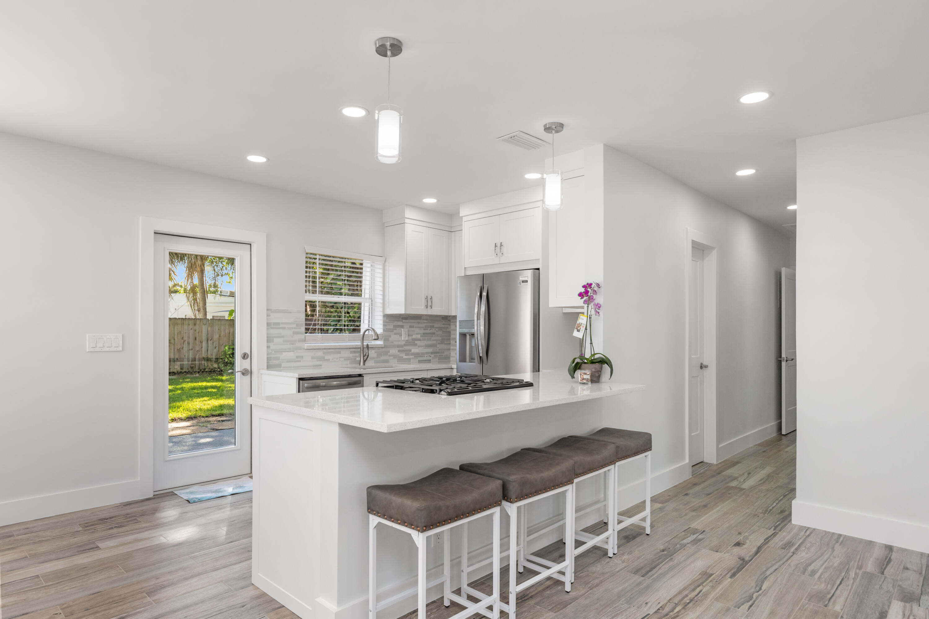 702 South 12th Street Lantana, FL 33462 - Photo 3 of 26 a kitchen with stainless steel appliances granite countertop a refrigerator and a stove top oven