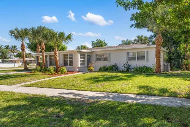 a view of a house with a backyard porch and sitting area