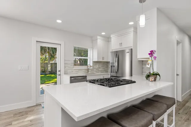 a stove top oven sitting inside of a kitchen