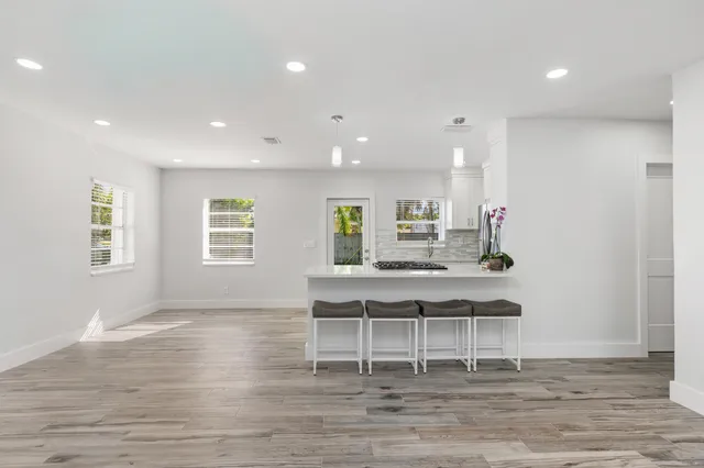 a view of a workspace with wooden floor and a ceiling fan
