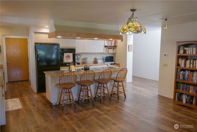 a view of a dining room with furniture and a book shelf