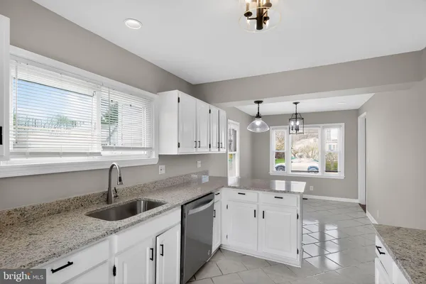 a kitchen that has a sink and a stove in it