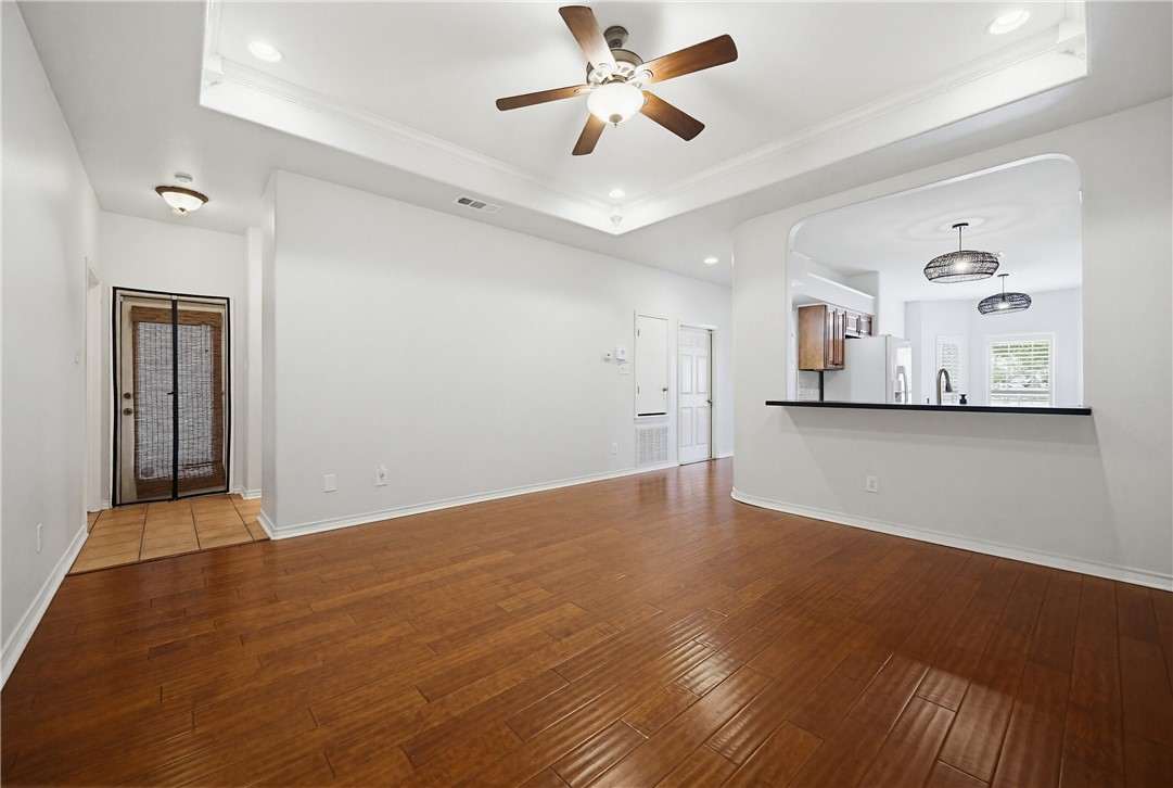 7251 Prairie Drive, Unit 6 Corpus Christi, TX 78413 - Photo 11 of 28 a view of a big room with wooden floor and a ceiling fan