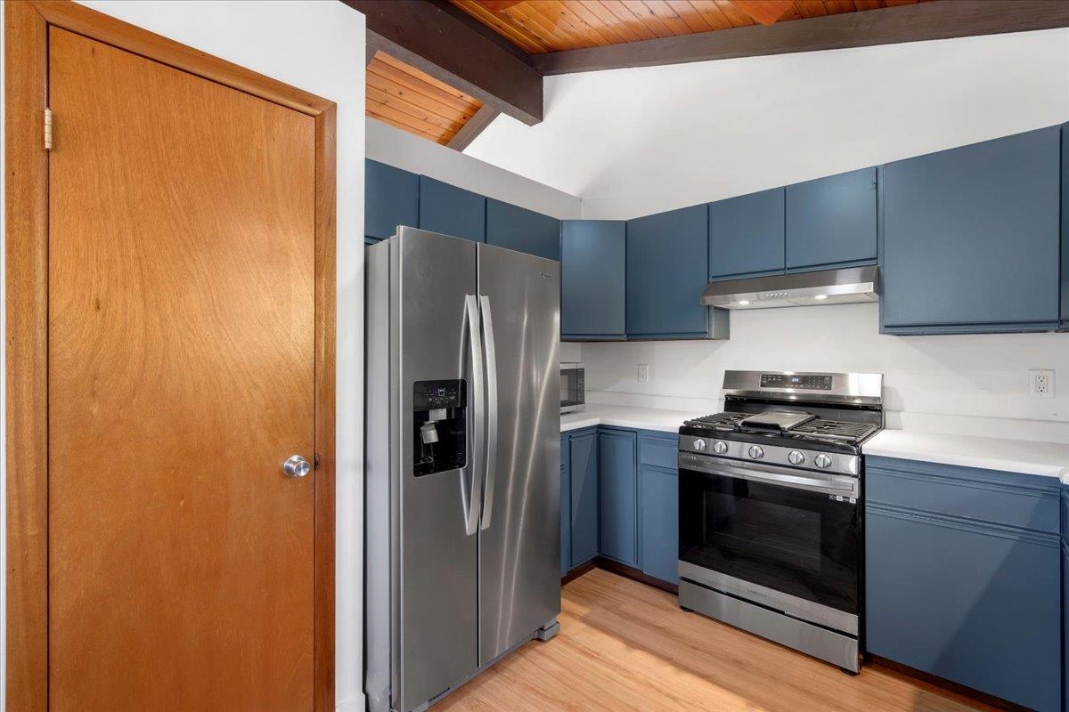 2130 Kauhikoa Road, Unit A Haiku, HI 96708 - Photo 8 of 43 a kitchen with a stove and a refrigerator
