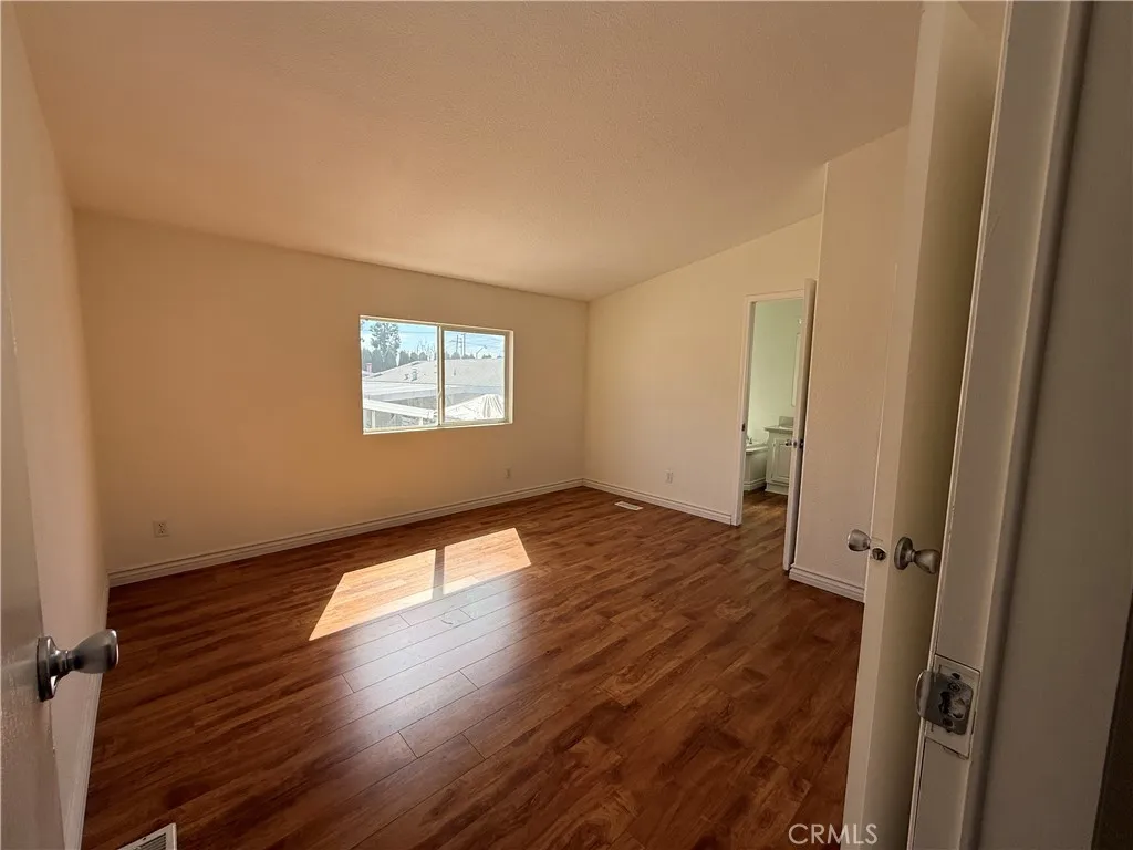 1051 Site, Unit 255 Brea, CA 92821 - Photo 13 of 30 an empty room with wooden floor and windows