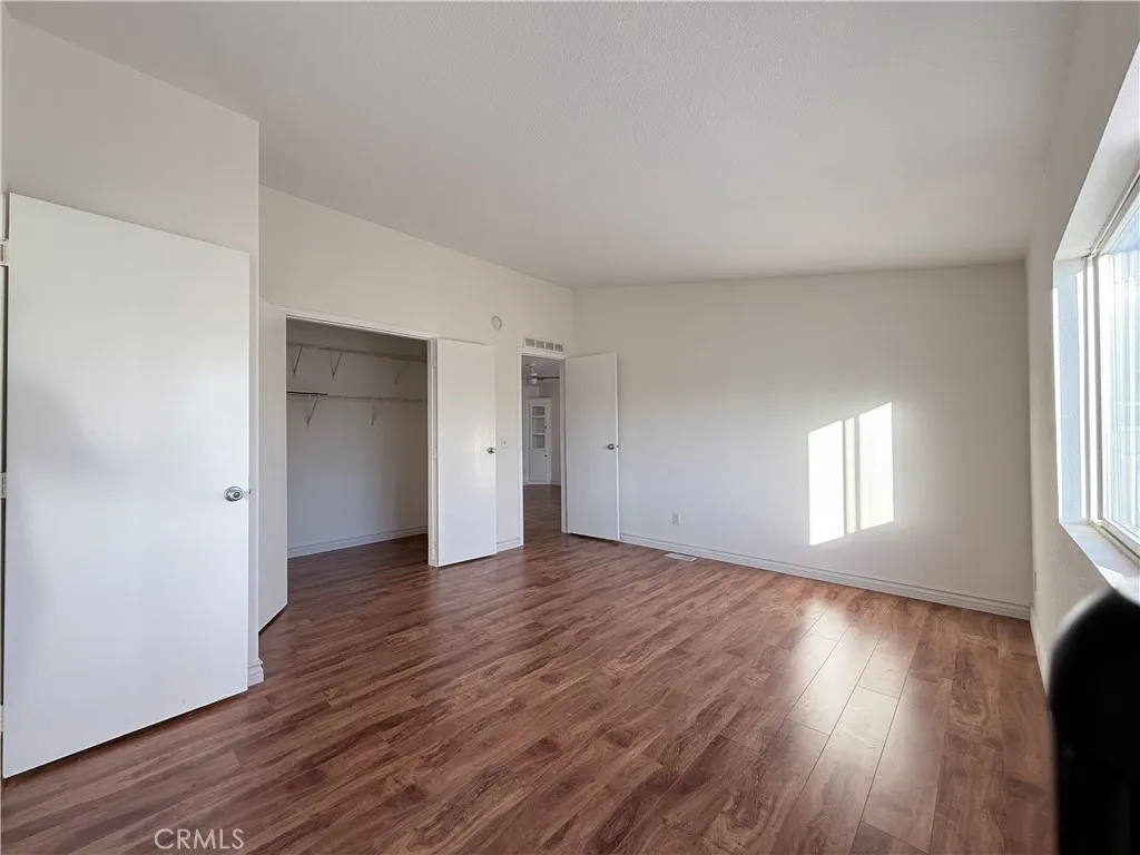 1051 Site, Unit 255 Brea, CA 92821 - Photo 14 of 30 an empty room with wooden floor and window
