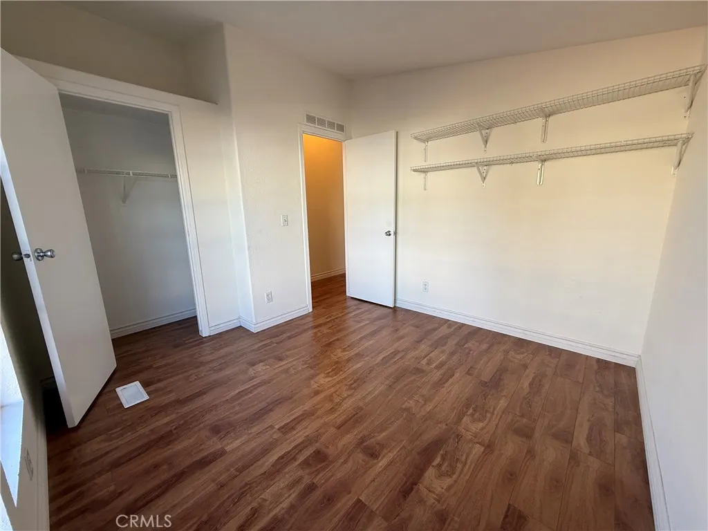 1051 Site, Unit 255 Brea, CA 92821 - Photo 18 of 30 an empty room with wooden floor and entrance