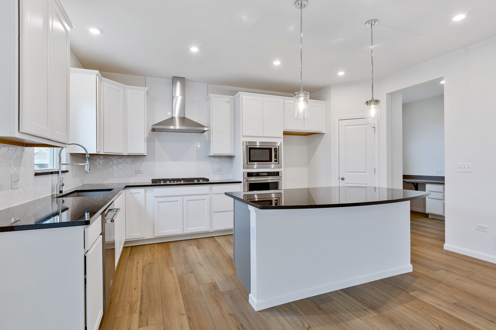 2120 Schmitt Circle Algonquin, IL 60102 - Photo 14 of 24 a kitchen with stainless steel appliances granite countertop a stove a sink a refrigerator and white cabinets with wooden floor