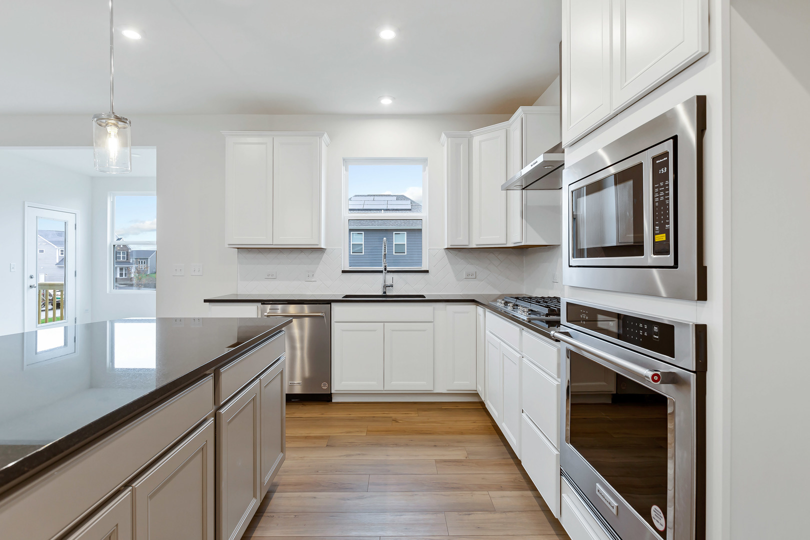 2120 Schmitt Circle Algonquin, IL 60102 - Photo 17 of 24 a kitchen with stainless steel appliances granite countertop a sink and stove top oven