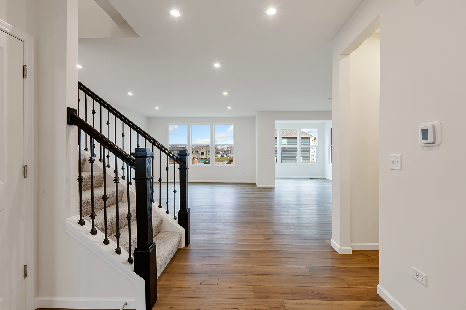 2120 Schmitt Circle Algonquin, IL 60102 - Photo 3 of 24 a view of a hallway with wooden floor and staircase