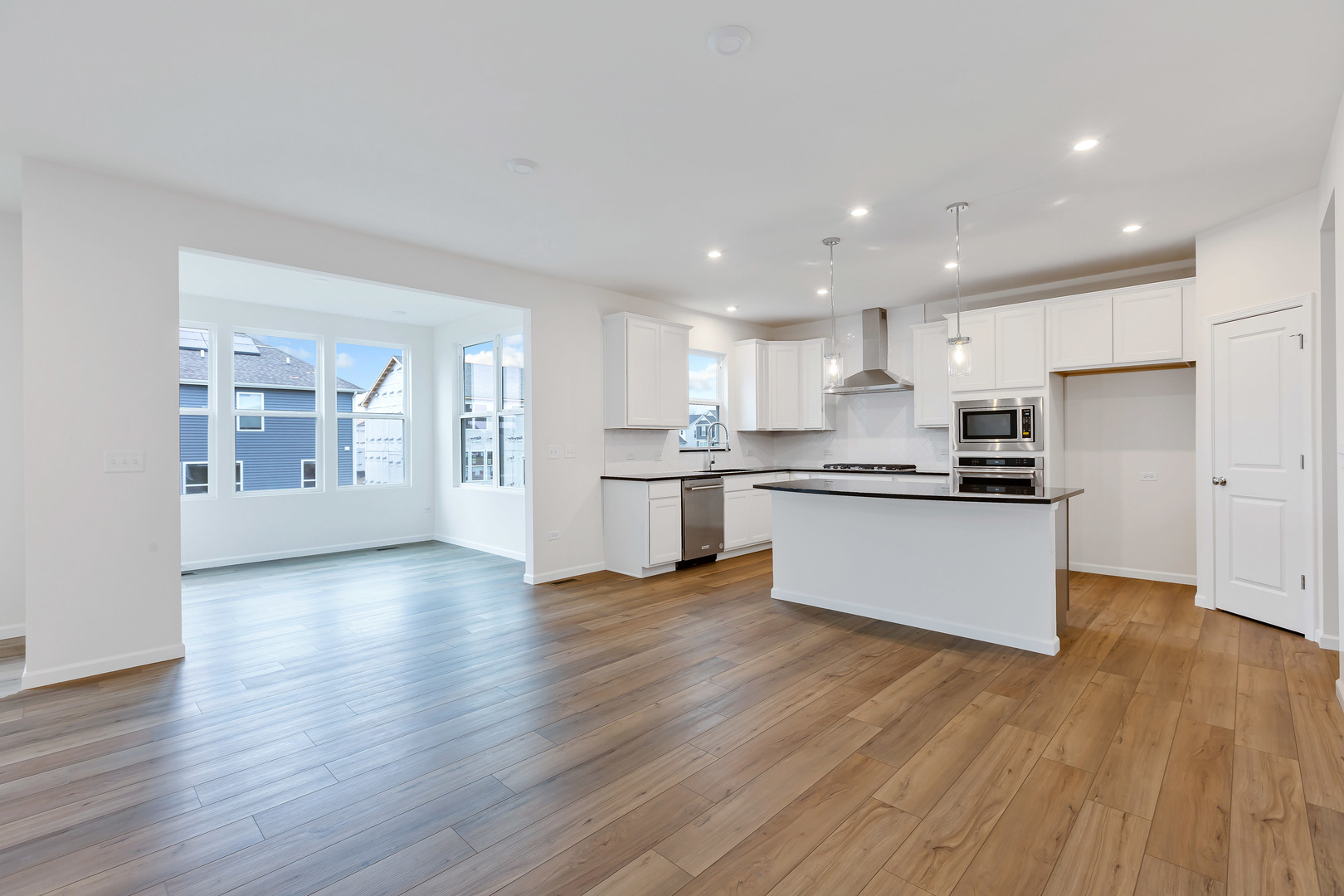 2120 Schmitt Circle Algonquin, IL 60102 - Photo 9 of 24 a view of kitchen with kitchen island wooden floors stainless steel appliances and cabinets