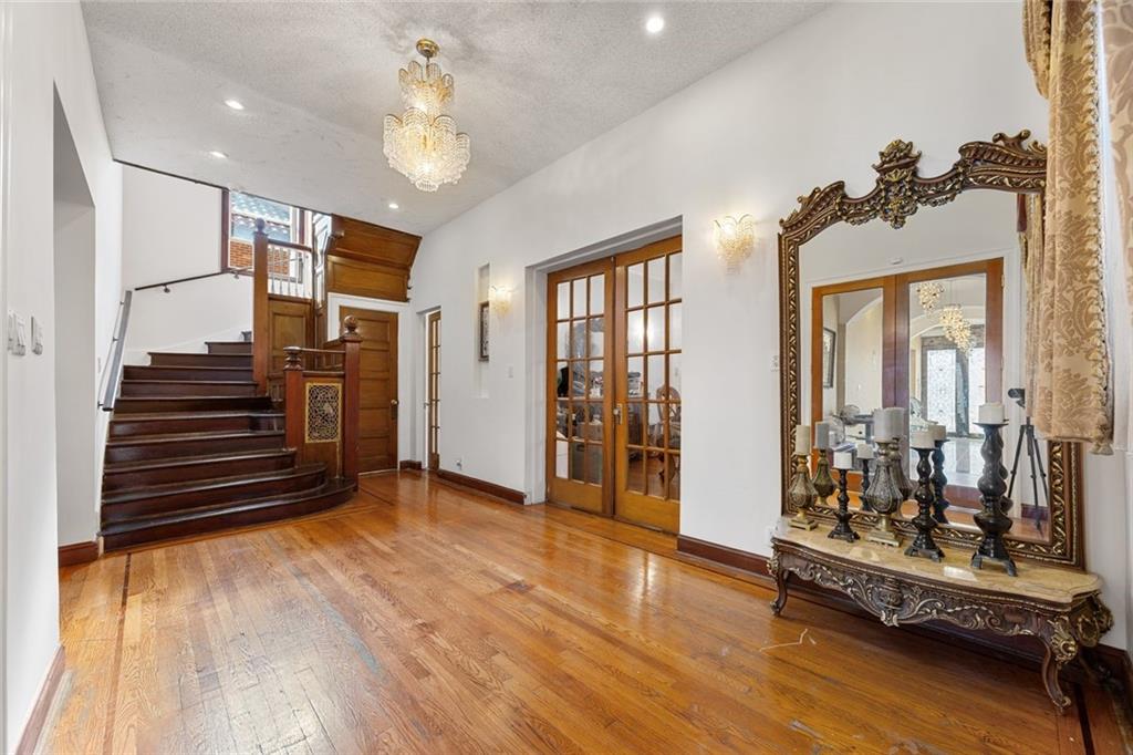 139 86th Street Brooklyn, NY 11209 - Photo 11 of 34 a view of a room with wooden floor and stairs