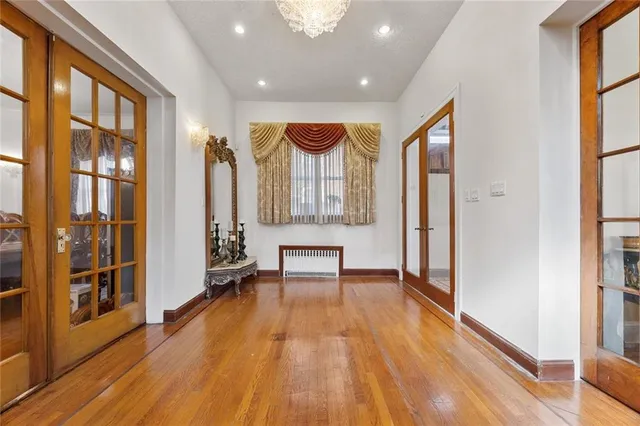 a view of a room with furniture and wooden floor