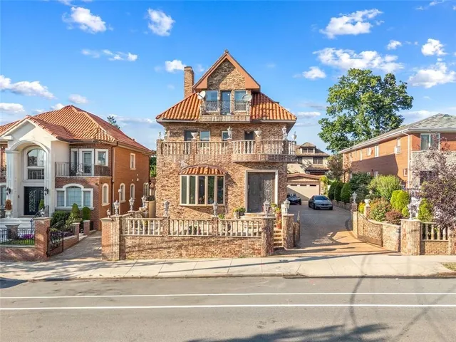 a front view of a residential apartment building with a yard