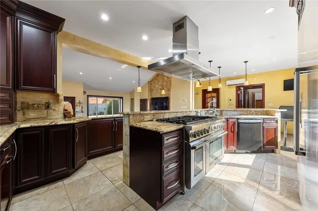 a kitchen with stainless steel appliances granite countertop a stove and a sink