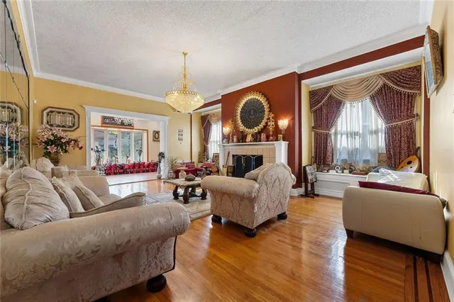 a living room with fireplace furniture and a large window