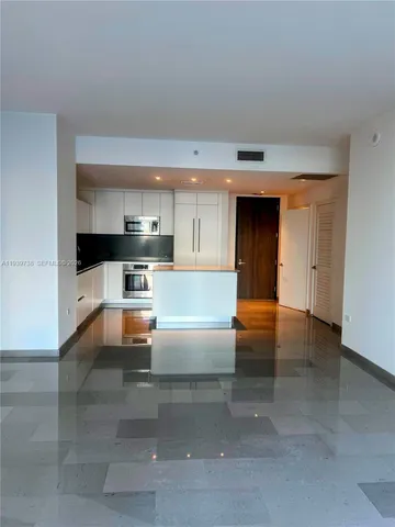 a view of kitchen with kitchen island a sink stainless steel appliances and cabinets