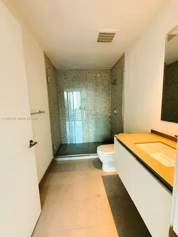 a bathroom with a sink a toilet and a shower
