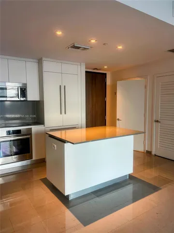 a kitchen with stainless steel appliances a stove and a refrigerator