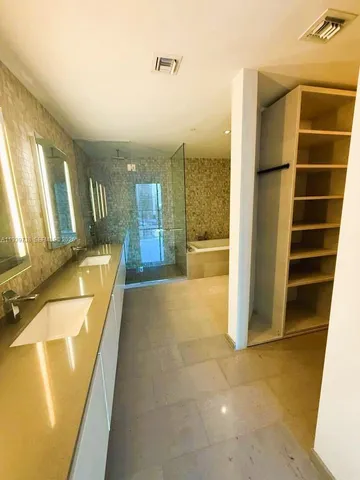 a view of a bathroom with tub and door
