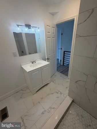 a bathroom with a sink a toilet and mirror