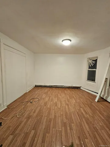 a view of an empty room and wooden floor