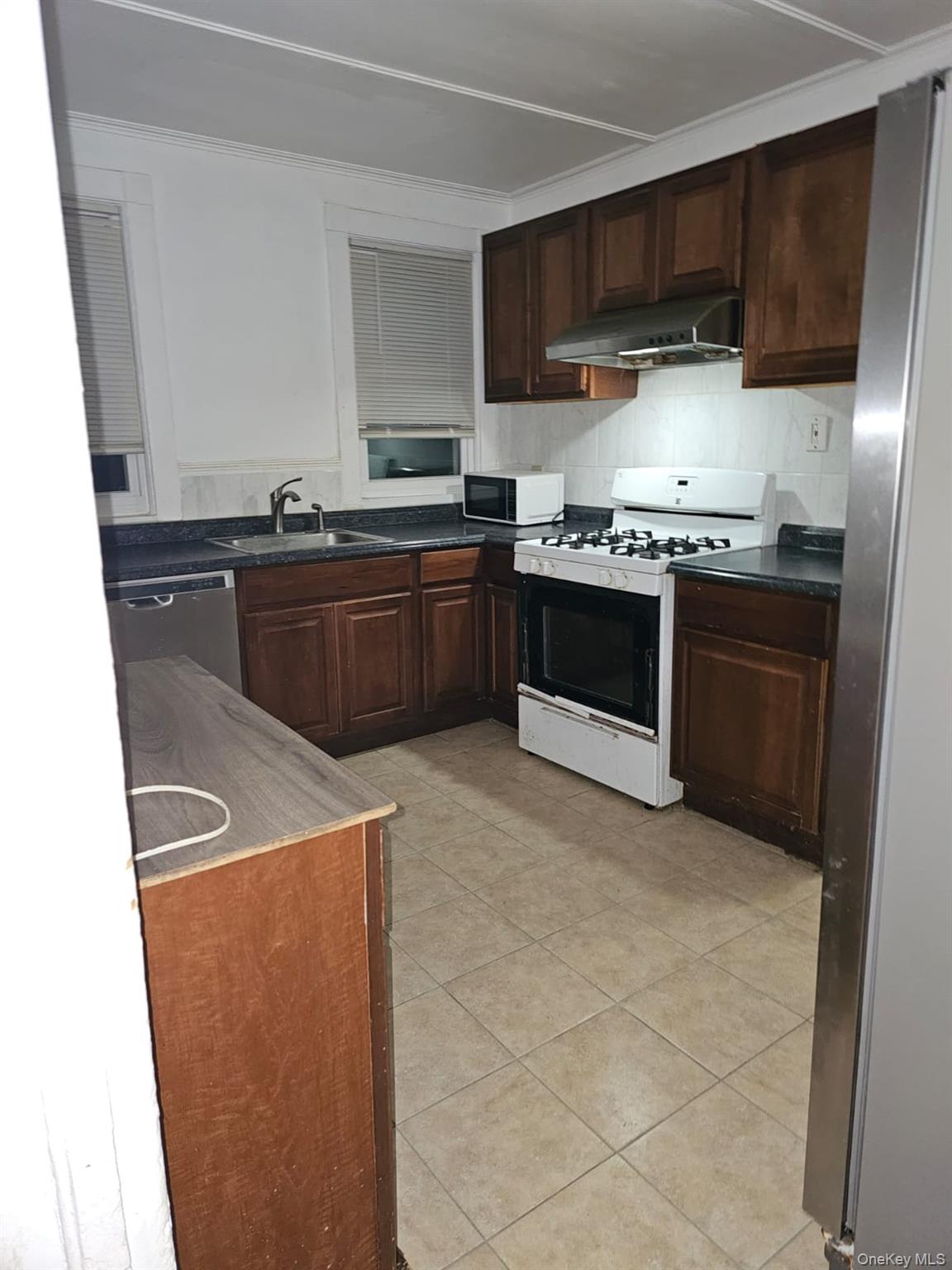 36 Prospect Street Middletown, NY 10940 - Photo 3 of 12 a kitchen with stainless steel appliances granite countertop a stove a refrigerator and a sink