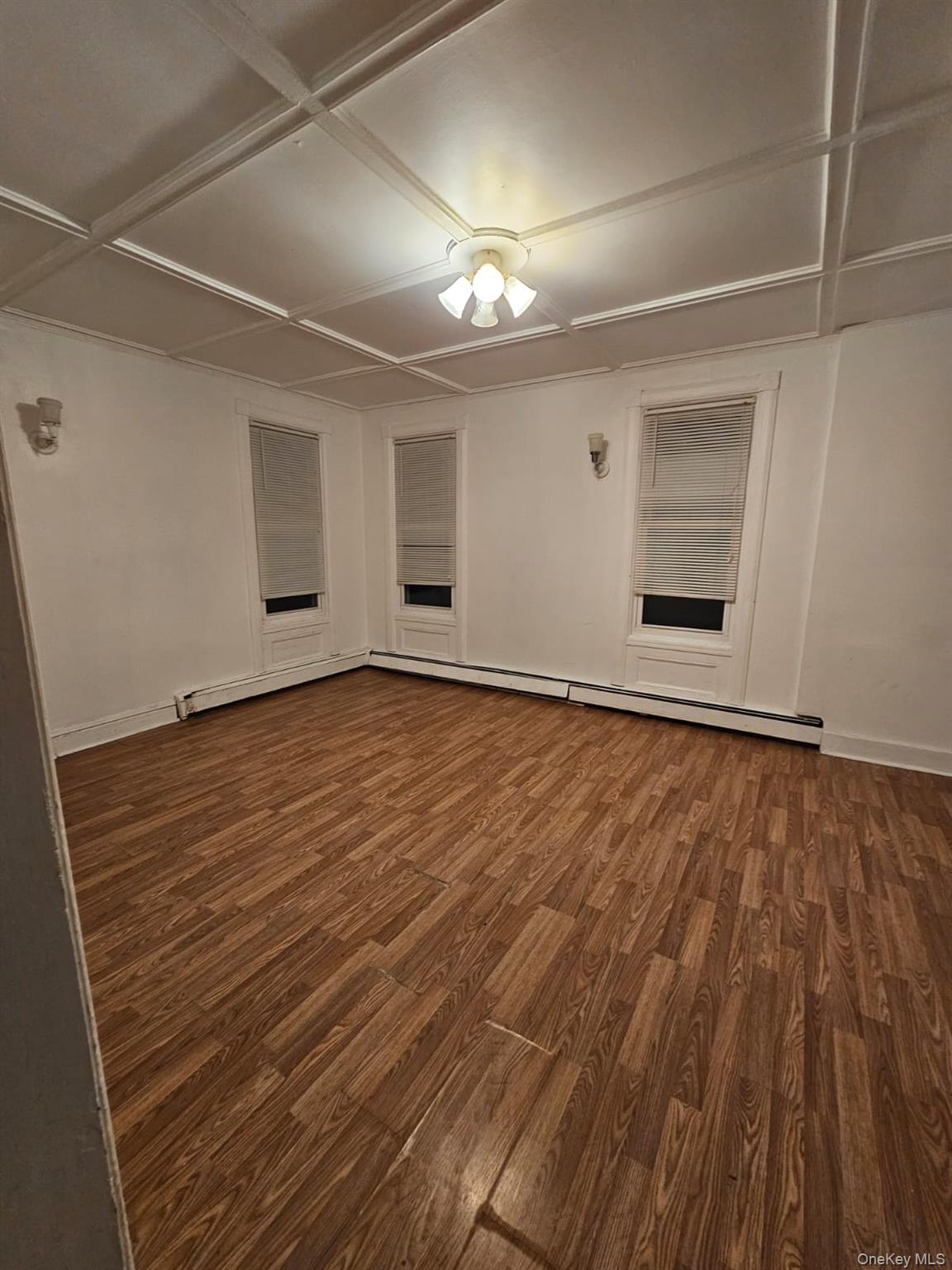 36 Prospect Street Middletown, NY 10940 - Photo 4 of 12 en empty room with wooden floor and window