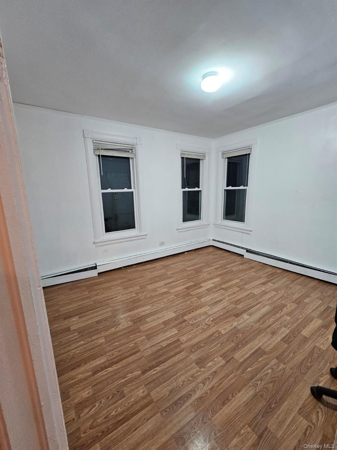 36 Prospect Street Middletown, NY 10940 - Photo 5 of 12 a view of an empty room with wooden floor and windows