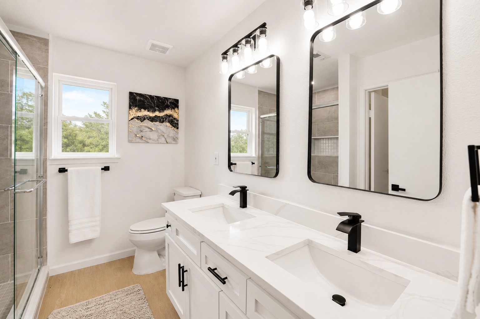 12703 Redfern Drive Houston, TX 77048 - Photo 15 of 28 Stylishly updated primary bathroom with dual vanities, modern fixtures, and sleek finishes—offering both functionality and a clean, contemporary feel.