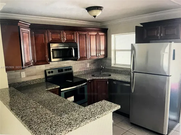a kitchen with a refrigerator stove and microwave