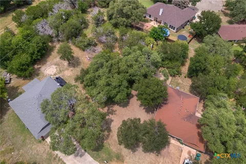 an aerial view of a house with a yard