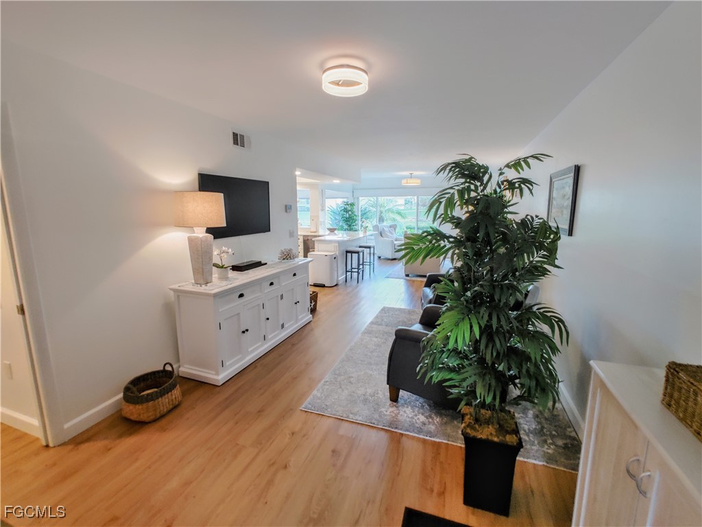 5830 Trailwinds Drive, Unit 813 Fort Myers, FL 33907 - Photo 14 of 39 a living room with furniture and a flat screen tv