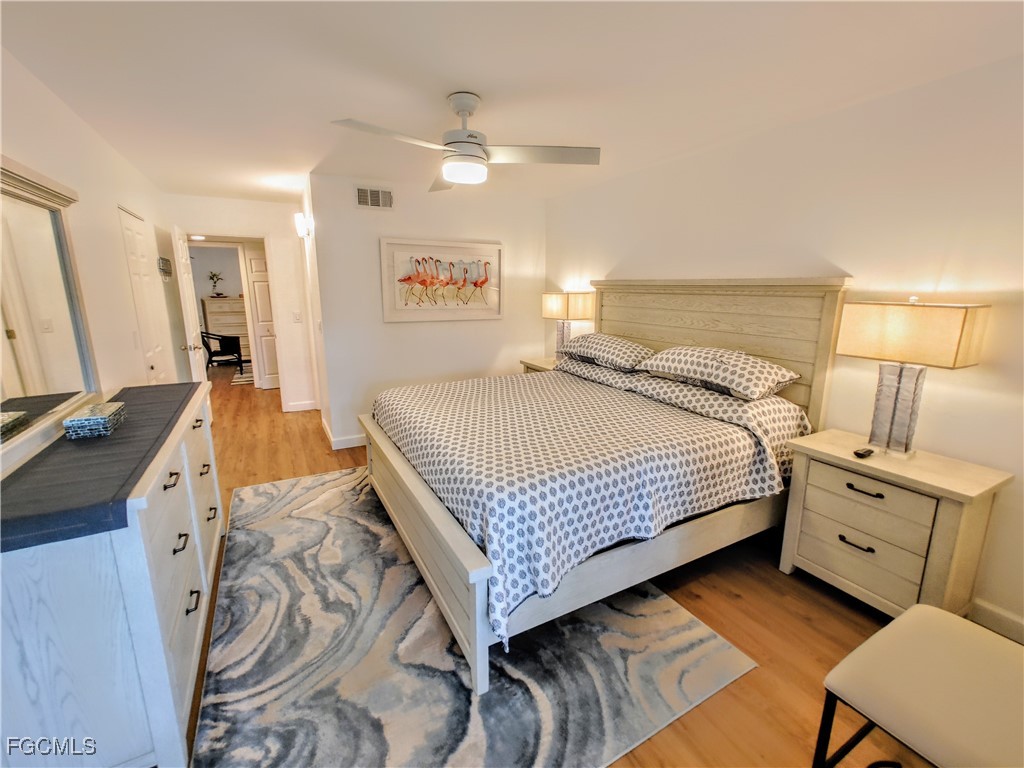 5830 Trailwinds Drive, Unit 813 Fort Myers, FL 33907 - Photo 17 of 39 a bedroom with a bed and attached view of kitchen